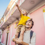 Dad And Son Tourists On The Street In The Portugese Style Romani In Phuket Town. Also Called Chinatown Or The Old Town. Traveling With Kids Concept